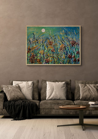 Meadow Moon by Svetla Stoyanova Bassi in a light wood frame above a grey sofa with cushions