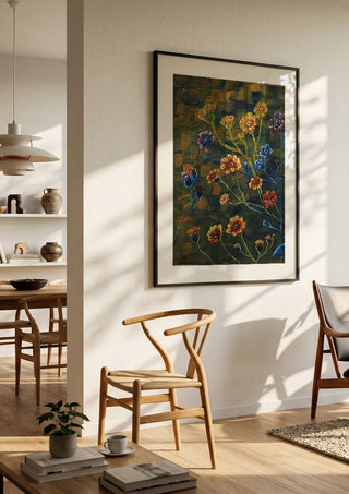 Field Flowers in Olive by Svetla Stoyanova Bassi in a black frame in a bright dining room with wooden chairs