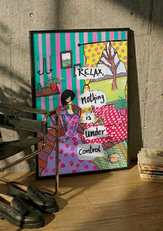 Nothing Is Under Control by Camilla Nilsson in a black frame leaning against a concrete wall by a steel chair