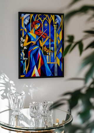 The Violinist at the Window by Andreas Gerlach in a black frame above a glass table with crystal glassware