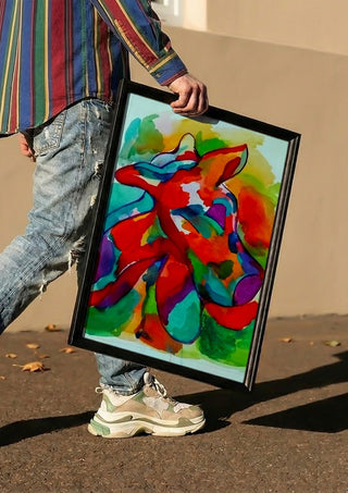 Color Pitbull 2 by Nittaart carried in a black frame along a sunny street