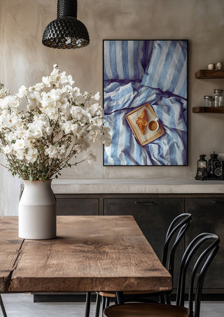 A Cozy Sunday in Bed by Ohkimiko in a black frame above a rustic table with white flowers