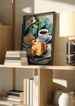 Petit dejeuner - coffee and croissants by Ohkimiko in a dark frame on a wooden shelf beside books and a lamp
