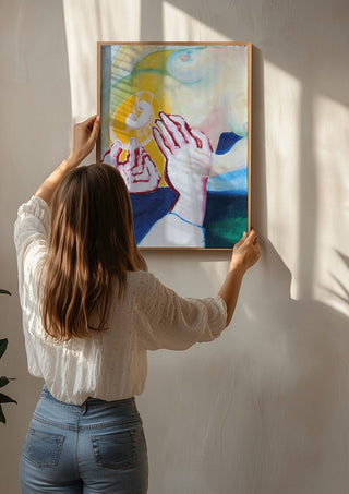 Between the Hands by António D'Albuquerque being hung on a sunlit wall