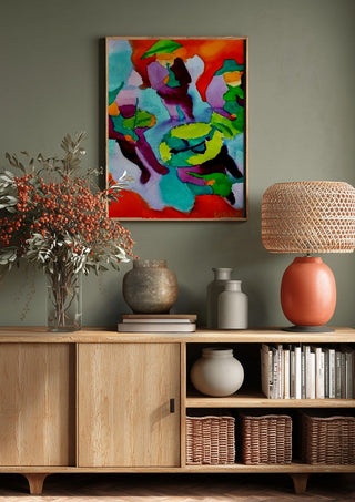 Mariachis by Nittaart above a wooden sideboard on a sage green wall