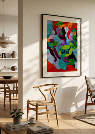 Mariachis by Nittaart in a black frame in a bright dining room with wooden chairs