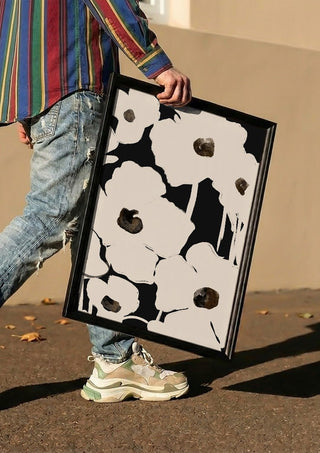 Abstract Flowers by ThingDesign carried in a black frame along a sunny street
