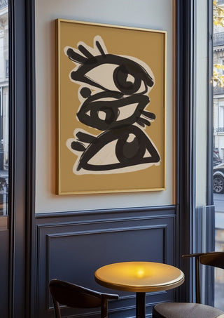 Abstract line art eyes 10 by ThingDesign in an oak frame on a panelled cafe wall