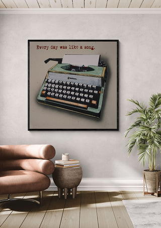 Like a Song by Carl Smith ART in a black frame above a leather armchair beside a palm