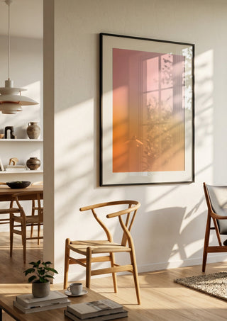 Sunset - cheerful, warm color gradient by Ohkimiko in a black frame in a bright dining room with wooden chairs