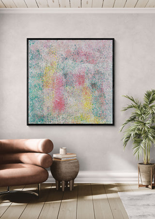 Between dream and light by Marcel Herrmann in a black frame above a leather armchair beside a palm