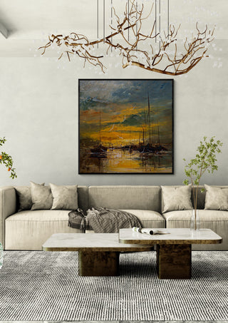 Evening Gold by Justyna Kopania in a black frame above a cream sofa under a branch chandelier