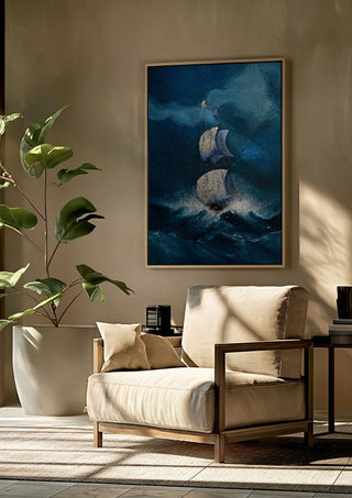 Sails in the Dark Swell by Justyna Kopania framed above a beige armchair beside a potted plant