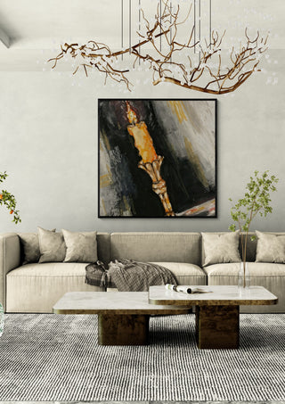 The night by Christin in a black frame above a beige sofa under a branch chandelier