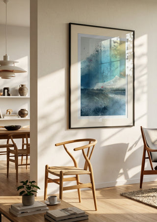 Blue October by Tania Zubareva in a black frame in a bright dining room with wooden chairs