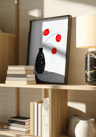 Three happy tulips by Creationsbyeditabrus in a dark frame on a wooden shelf beside books and a lamp