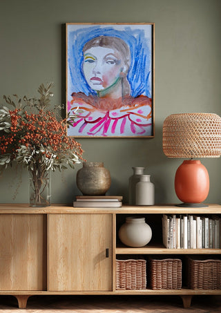 Who's the Clown now by DNF above a wooden sideboard on a sage green wall