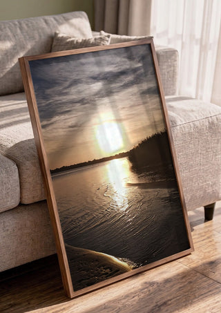 Light Finding the Shore by Bora Kőhalmi in a walnut frame leaning against a grey sofa