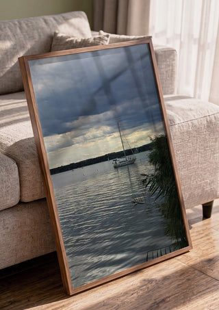 Light Reaching the Water by Bora Kőhalmi in a walnut frame leaning against a grey sofa