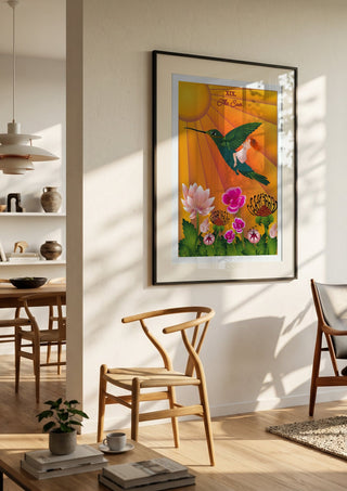 The Sun by Sciurus tarotus in a black frame in a bright dining room with wooden chairs