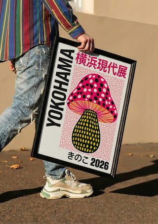 Pink Dot Mushroom Poster by Yokohama carried in a black frame along a sunny street