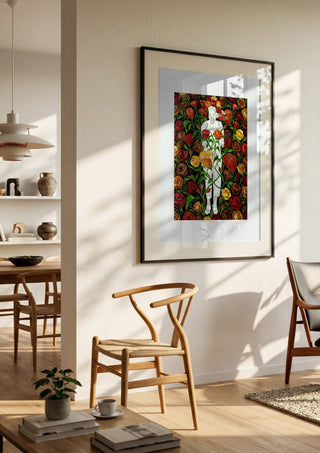 She stands in Bloom by Madame Petit in a black frame in a bright dining room with wooden chairs
