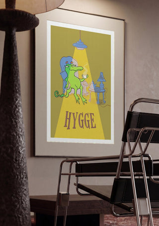 Hygge Crocodile - Yellow by Elisa Albanelli framed in a dim room beside a tubular steel chair