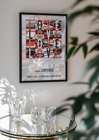 Danger Love4you - Type Signal by Amadeus Fuchs in a black frame above a glass table with crystal glassware