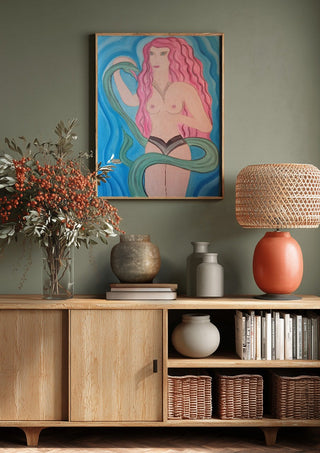 Eva in Paradise by Carmen Coduri above a wooden sideboard on a sage green wall
