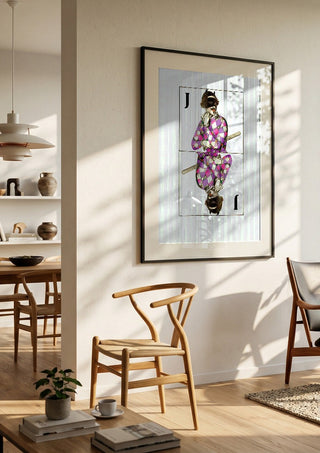 Joker by Bent Hardervig in a black frame in a bright dining room with wooden chairs