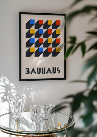 Bauhaus Grid by Neil Stevens in a black frame above a glass table with crystal glassware