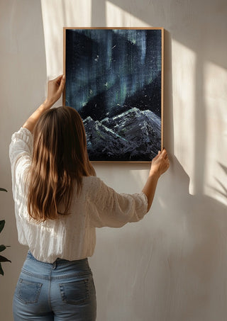 Aurora by Zhan Snow being hung on a sunlit wall