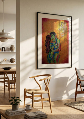Liebe und Psyche by Olaf Baier in a black frame in a bright dining room with wooden chairs