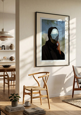 The Mountain Within by Fran Rodriguez in a black frame in a bright dining room with wooden chairs