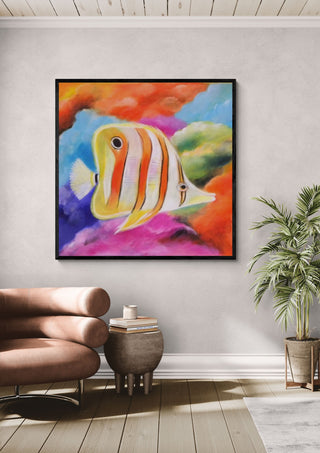 Happy Fish by Sunny in a black frame above a pink armchair beside a potted palm
