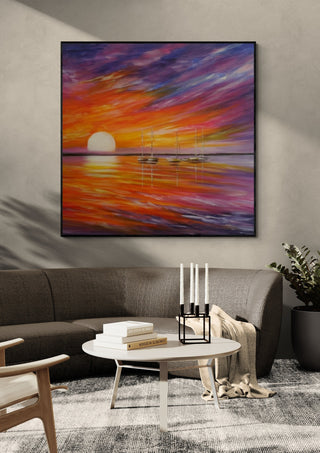 Colorful by Sunny in a black frame above a grey sofa with a round table and candlesticks