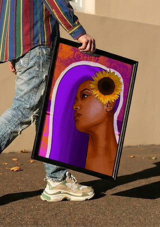 Golden Focus by Sabrina Rosenblatt carried in a black frame along a sunny street