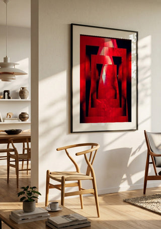 Corazon by Carlos Enrique Gozalo Ara in a black frame in a bright dining room with wooden chairs