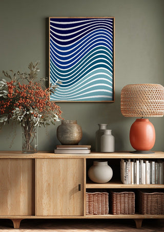Aallot by Aleksi Allan above a wooden sideboard on a sage green wall