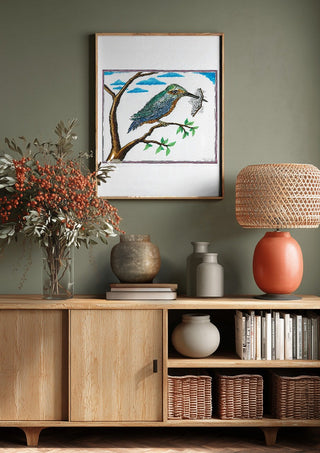 Bird with a Book by Waldemar Mandzel above a wooden sideboard on a sage green wall