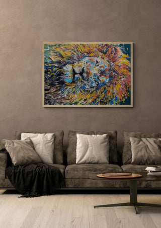 Soul of a lion by Bibi in a pale wooden frame above a grey sofa with cushions