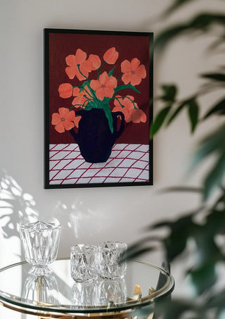 Rosa blomster på rutig duk by Rebecka Hansson in a black frame above a glass table with crystal glassware