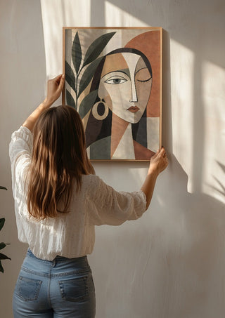 Cubist Woman Portrait with Plant by TimlessArtworks being hung on a sunlit wall