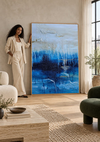 Rising Light by Sabine Halbrock leaning against a sunlit living room wall beside a woman