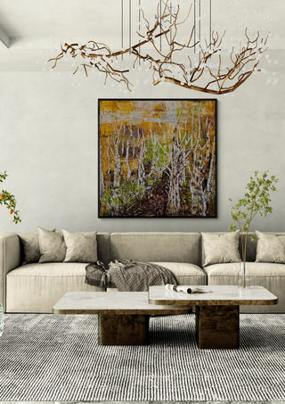 Release by Sabine Halbrock in a black frame above a beige sofa under a branch chandelier