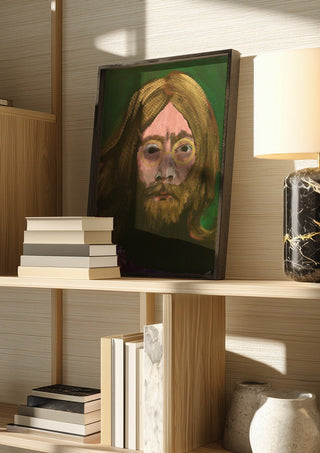 Lennon by Ian Frederick Harris in a dark frame on a wooden shelf beside books and a lamp