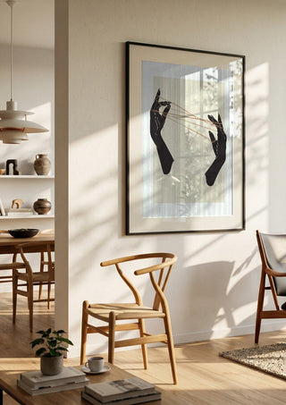Unclear plans by Nari in a black frame in a bright dining room with wooden chairs
