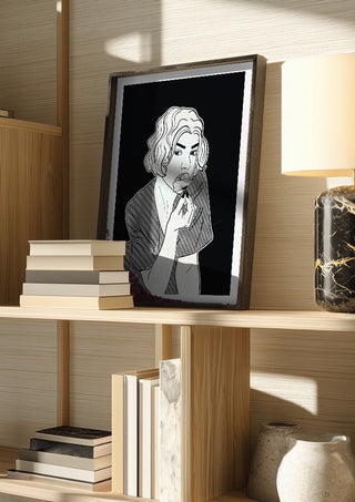 Poppy by Nari in a dark frame on a wooden shelf beside books and a lamp