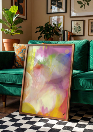Color rond by FridaRit in a wooden frame beside a green velvet sofa on a chequered floor