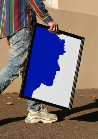 Projected personality by Tonia carried in a black frame along a sunny street
